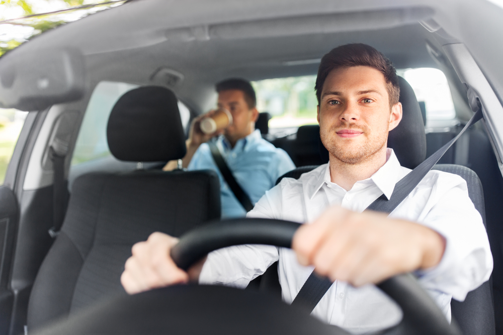 male driver driving a car with passenger